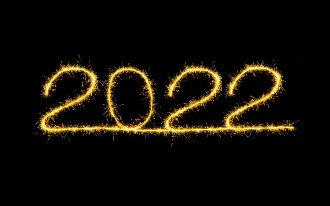 2022 written in gold tinsel or gold sparkling electric wire of some sort, on plain black background.