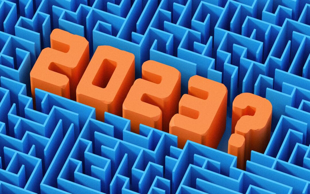 Looking down on a blue, plastic maze, with "2023?" in large orange plastic numbers sitting in the middle of the maze.
